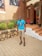 A satisfied customer standing next to a newly paved driveway.