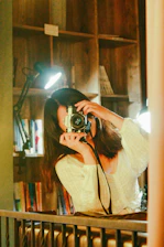 Professional photographer taking pictures inside the cozy hotel lobby.