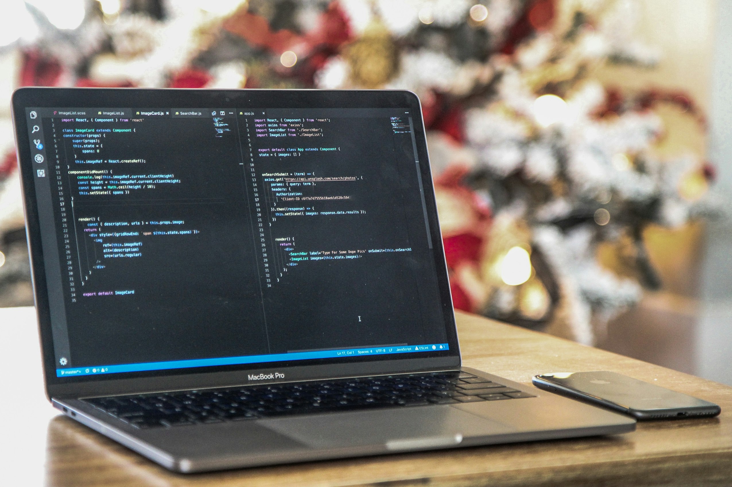 Macbook Pro on a brown table by Joshua Aragon