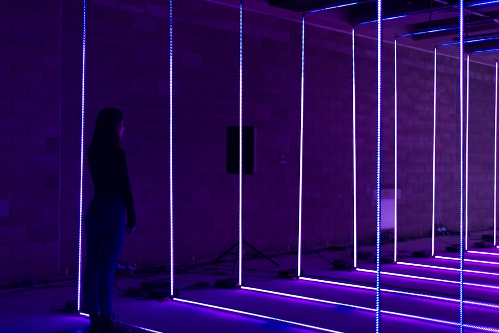 woman standing on purple led light string