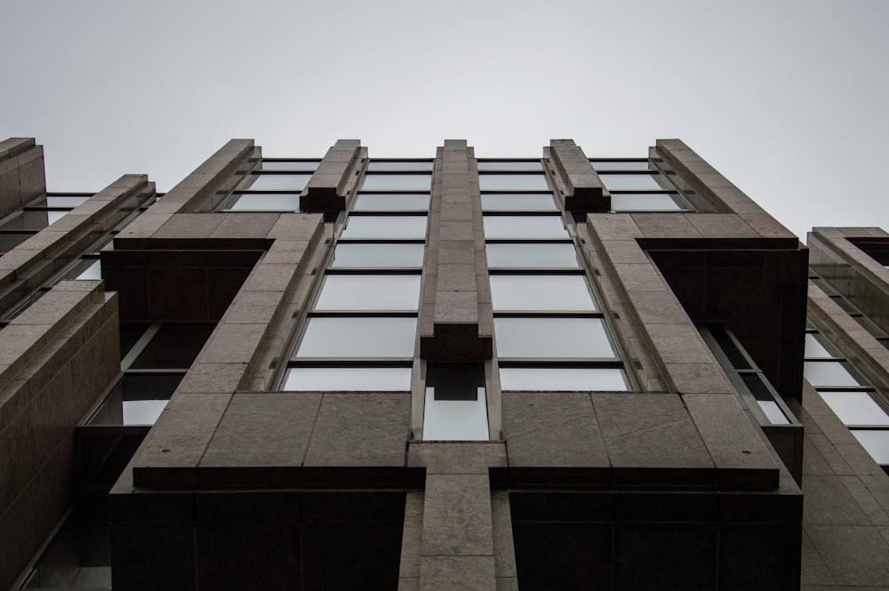 low angle photo of grey high rise building