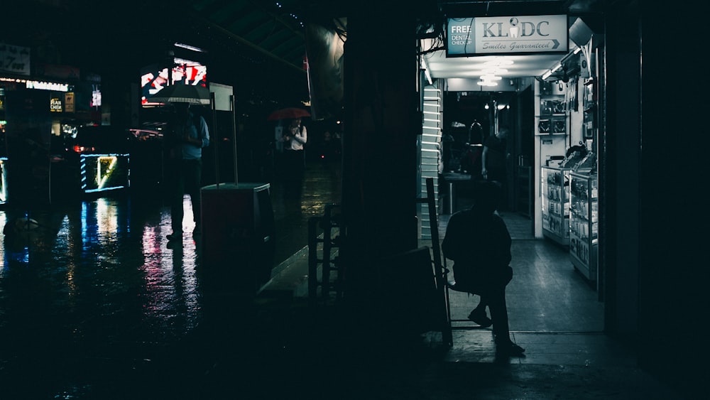 silhouette of person sitting under KL DC