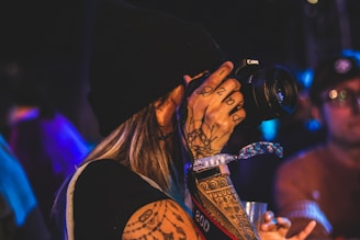 person using black DSLR camera