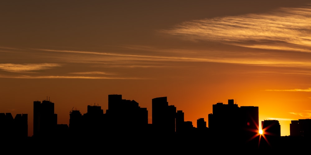 silhouette photo of buildings during sunset
