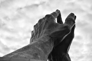 An elegant resin sculpture of intertwined hands symbolizing friendship
