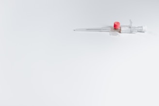 white and red syringe