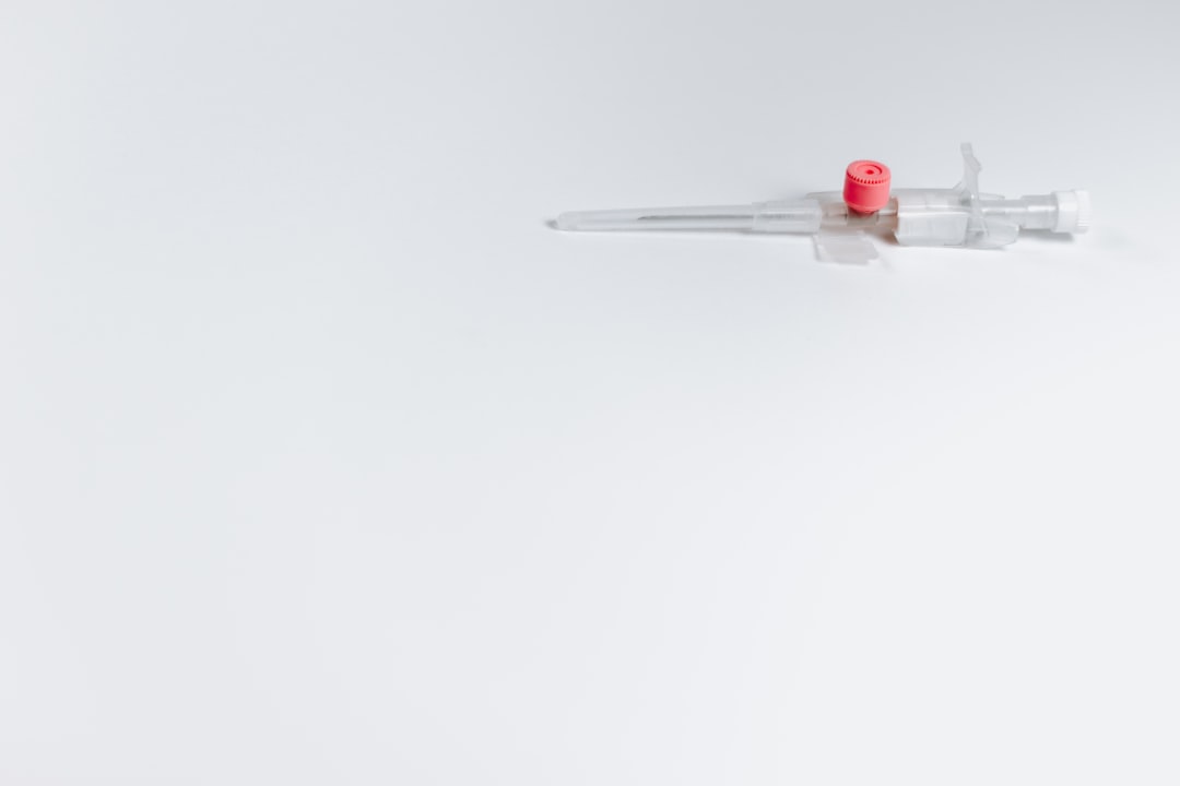 white and red syringe