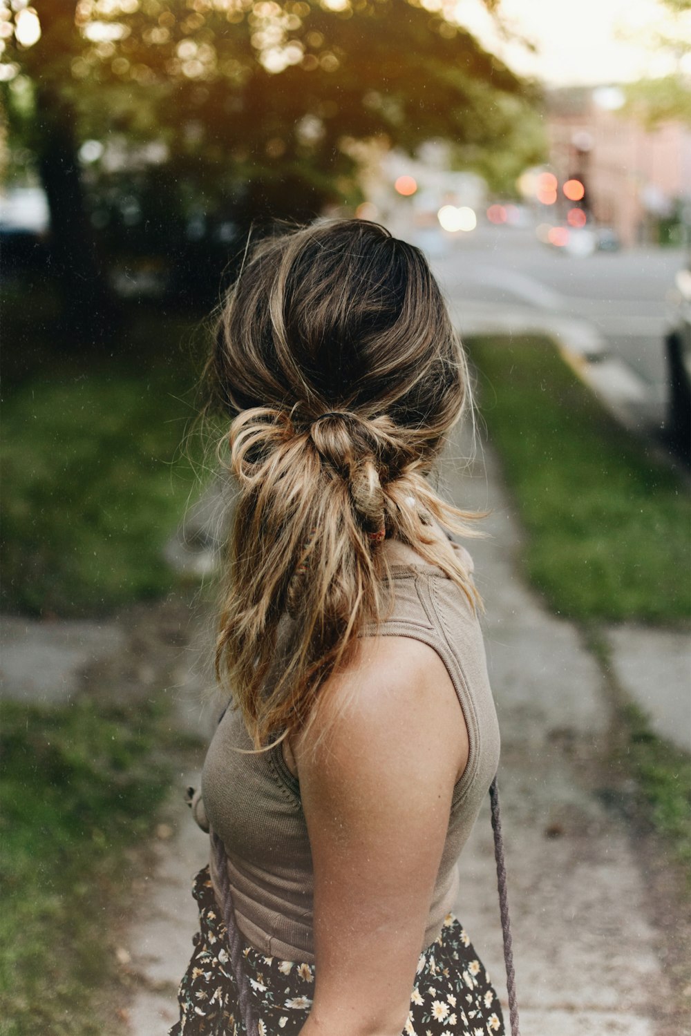 woman wearing brown tank top looking behind