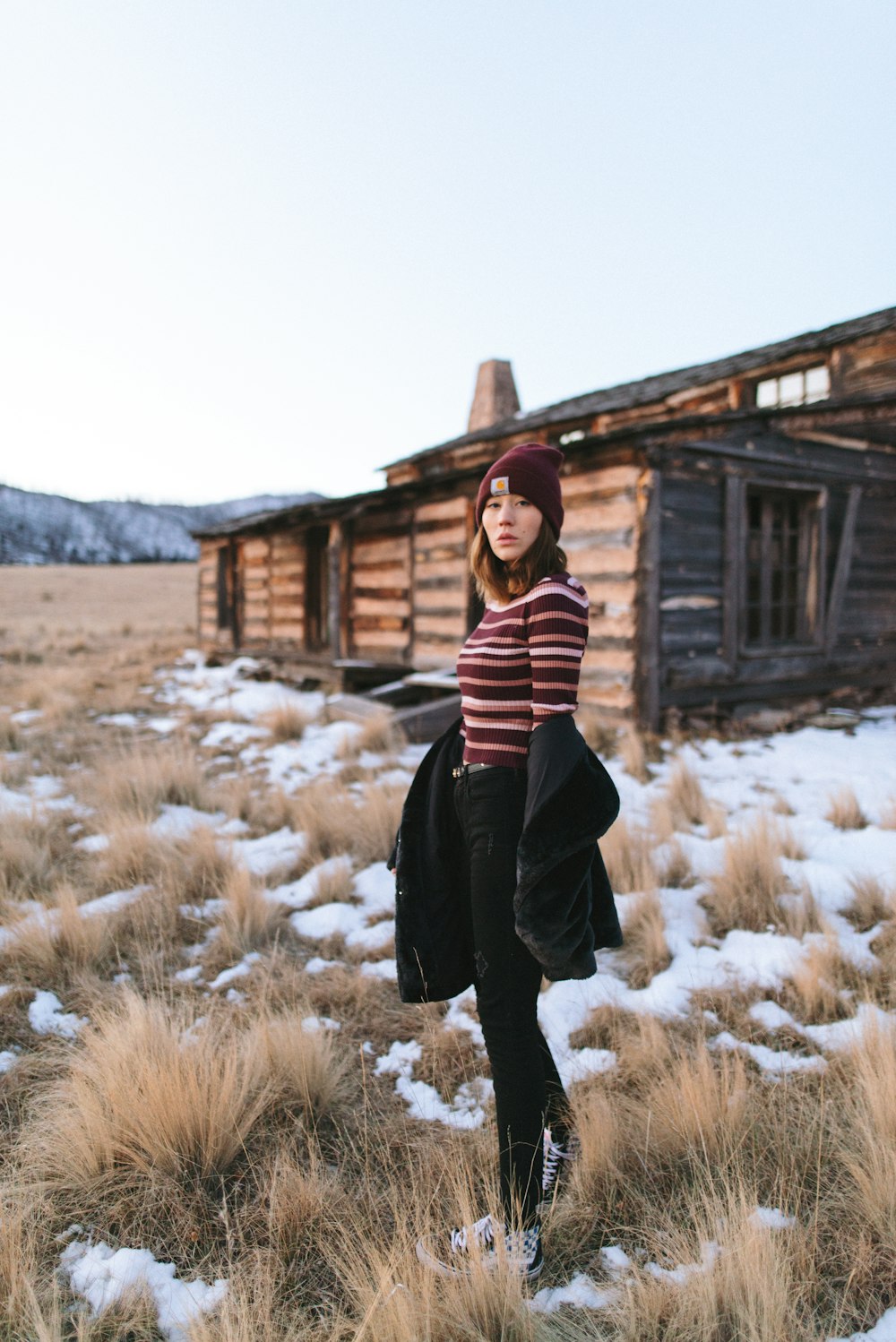 shallow focus photo of woman in maroon and brown striped long-sleeved shirt