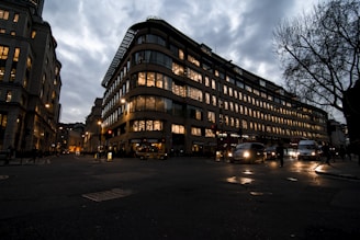 A modern taxi waiting outside a residential building in Kuwait at dusk.