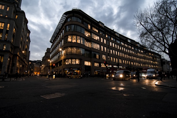 A modern taxi waiting outside a residential building in Kuwait at dusk.