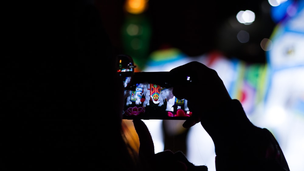 silhouette of person using smartphone