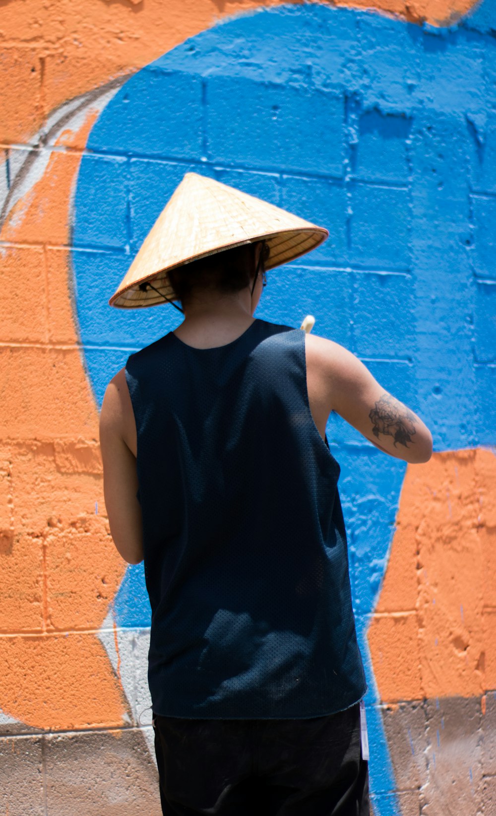 man wearing sleeveless top