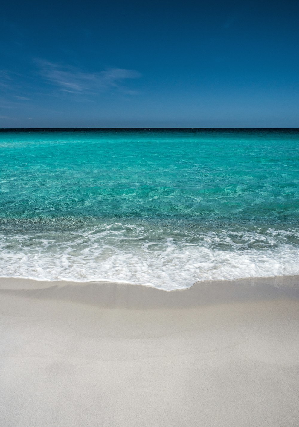 calm green sea under blue sky