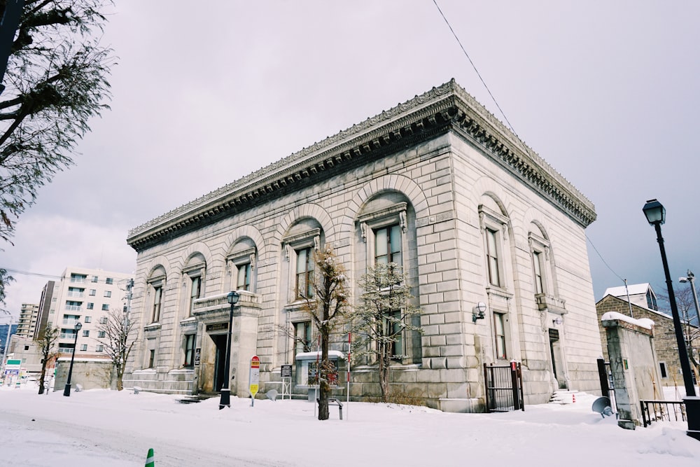 white and gray building in snow covered ground during daytime