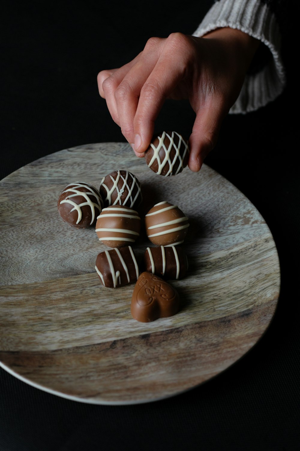 person holding chocolate ball