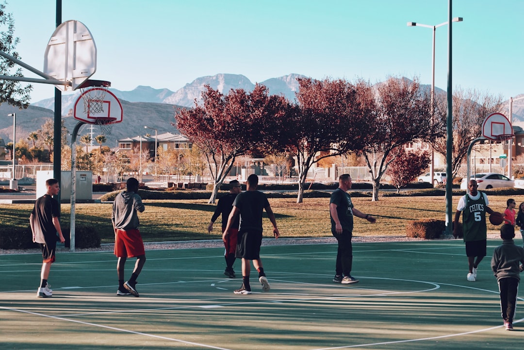 men playing basketball during daytime