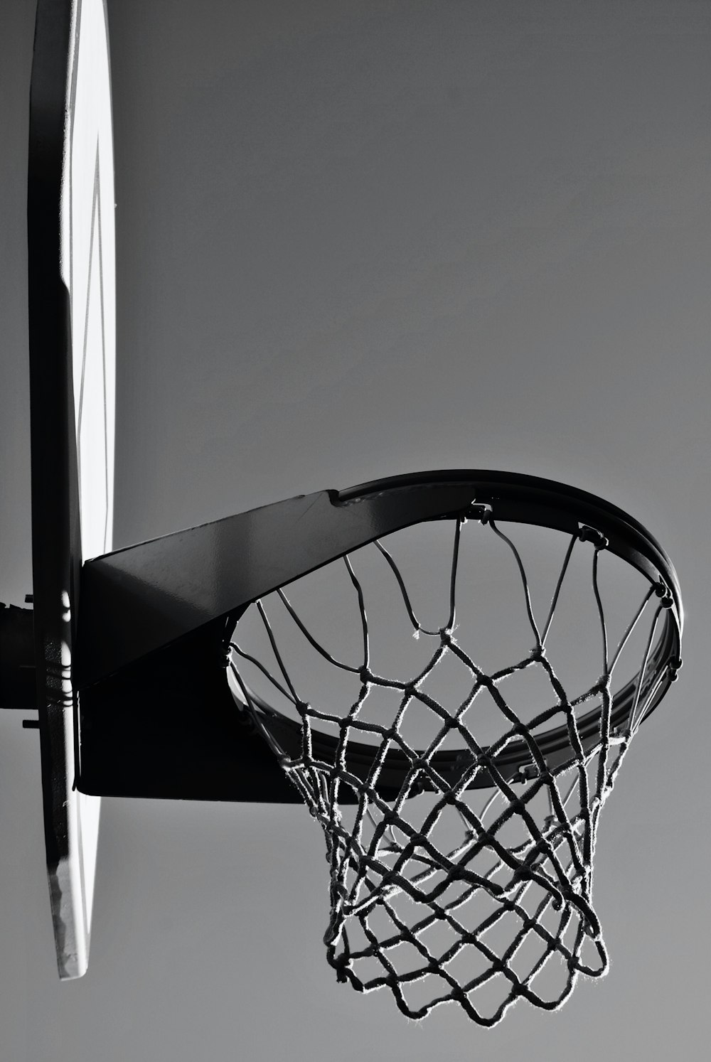 gray scale photo of basketball hoop