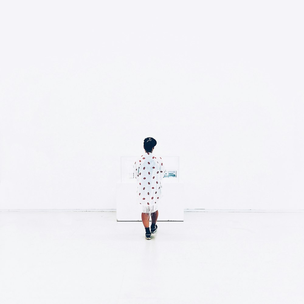 woman in white and red polka dot mini dress