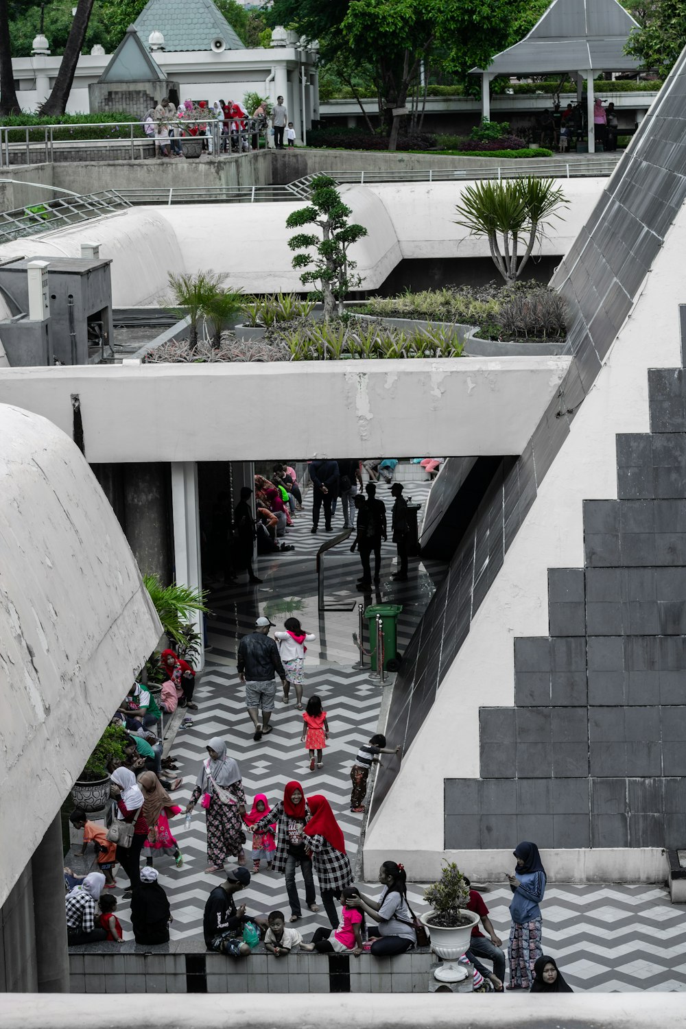 group of people between concrete building