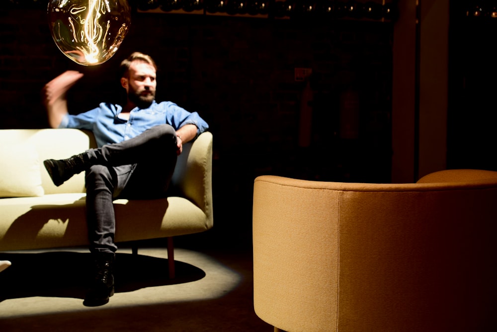 man sitting on yellow couch