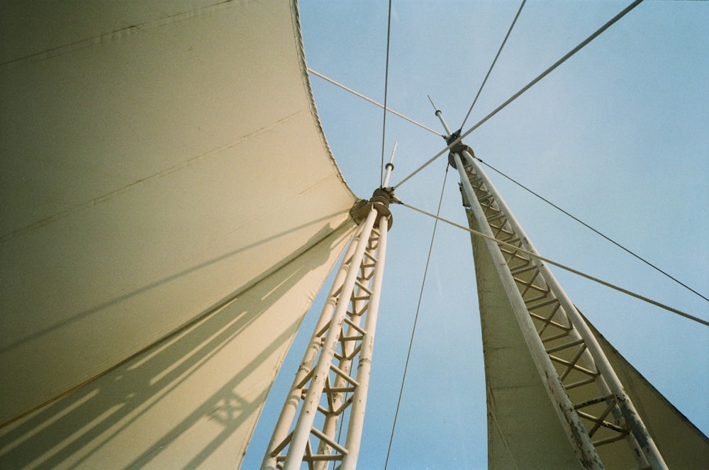 white sail in sailboat on daytime