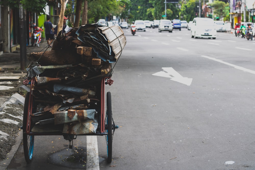 red and black push cart beside road