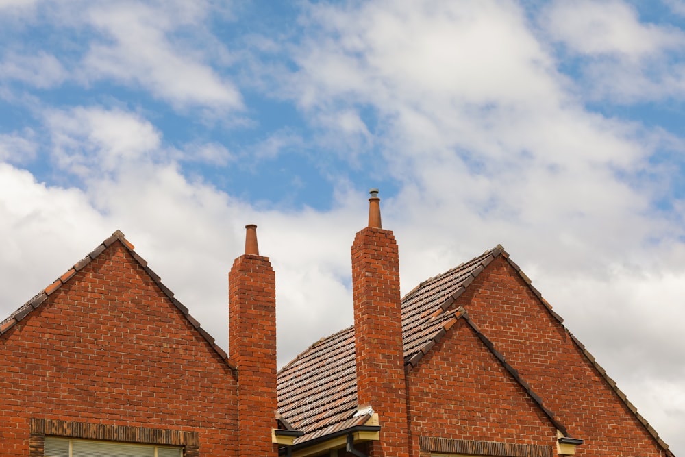 brown brick house across white clouds