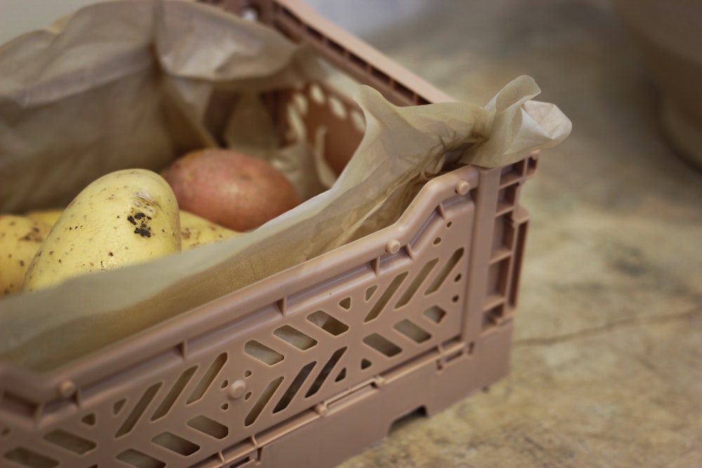 brown plastic crate with fruits