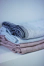 Detailed shot of quality linens and a neatly folded robe ready for guests.