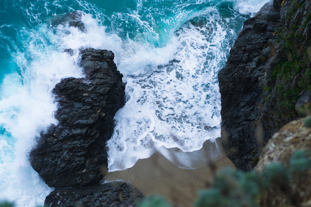 aerial photography of rock formation near sea