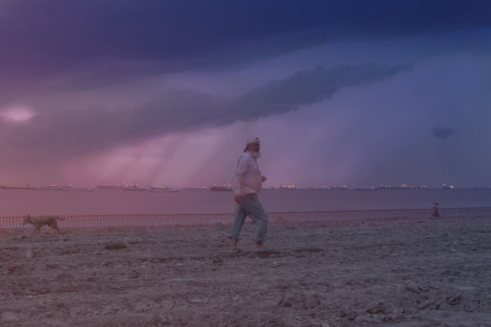 man walking on grass field