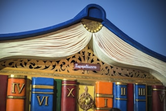 Anthony the mascot joyfully climbing a colorful hill made of books and numbers.