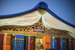 Stack of books with a crown placed on top, representing knowledge and royalty.