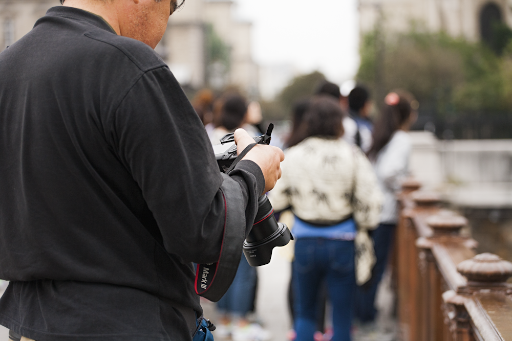 man checking his DSLR camera