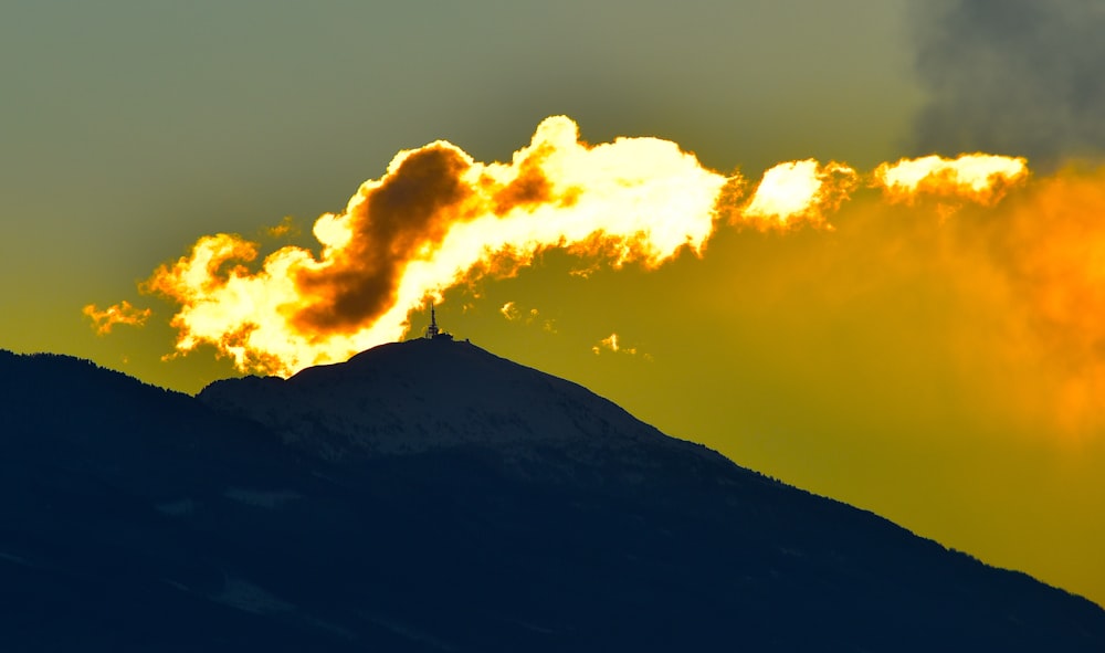 lighthouse on top of mountain during golden hour