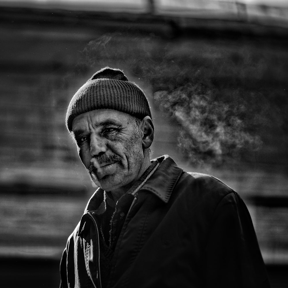 grayscale photography of smoking man