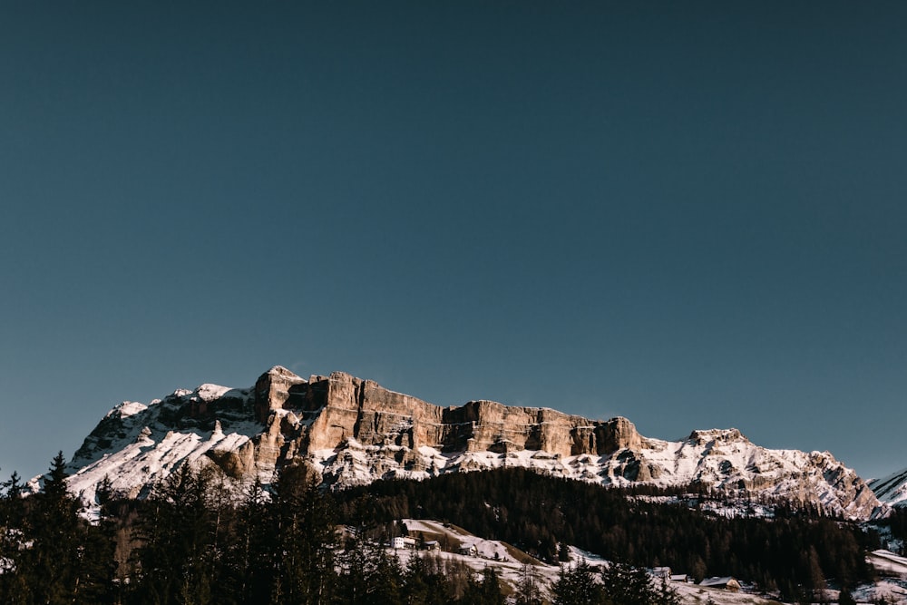 brown mountain across blue sky