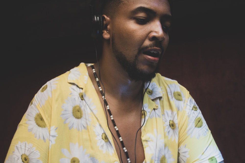 man wearing headphones and floral shirt