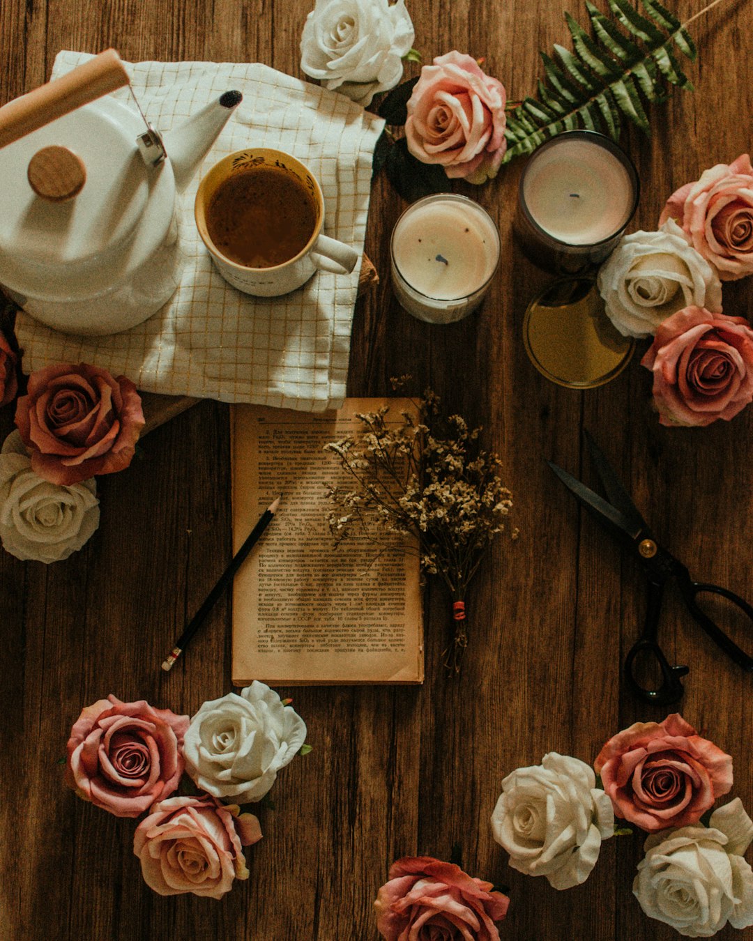 pink and white roses near white ceramic mug on table
