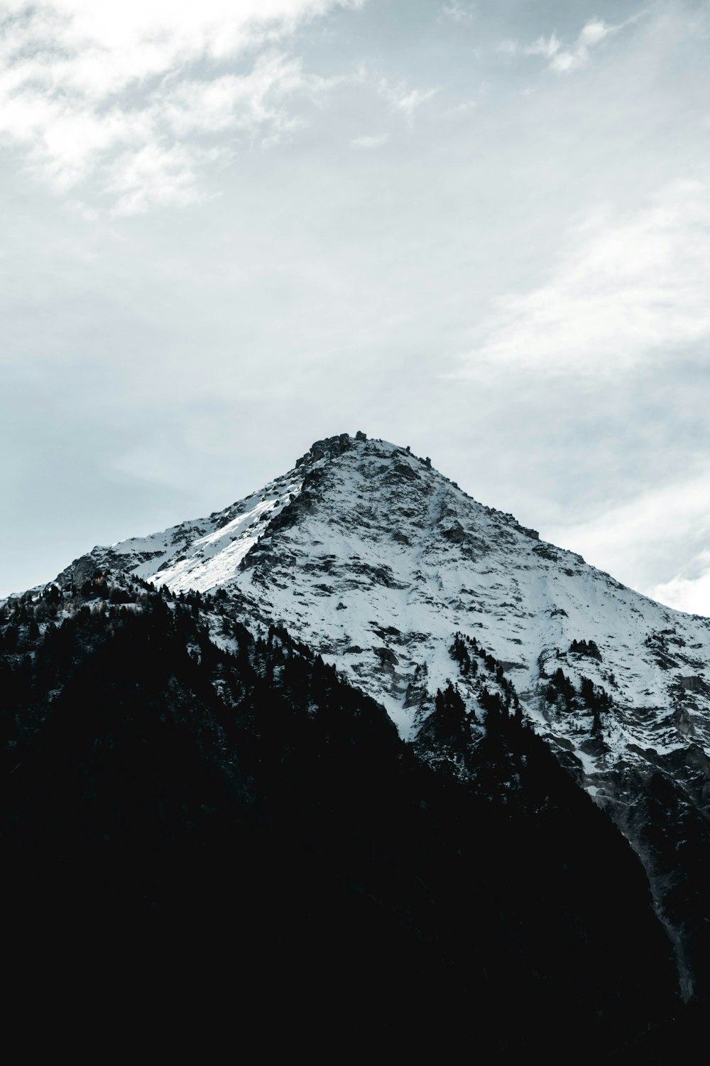 white mountain across clouds