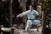 A focused karate practitioner performing a kata in a serene dojo setting.