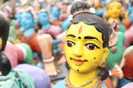 A collection of colorful clay figurines representing Indian culture.