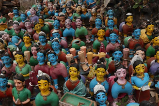 Group of smiling Mexican artisans proudly displaying their handcrafted pottery.