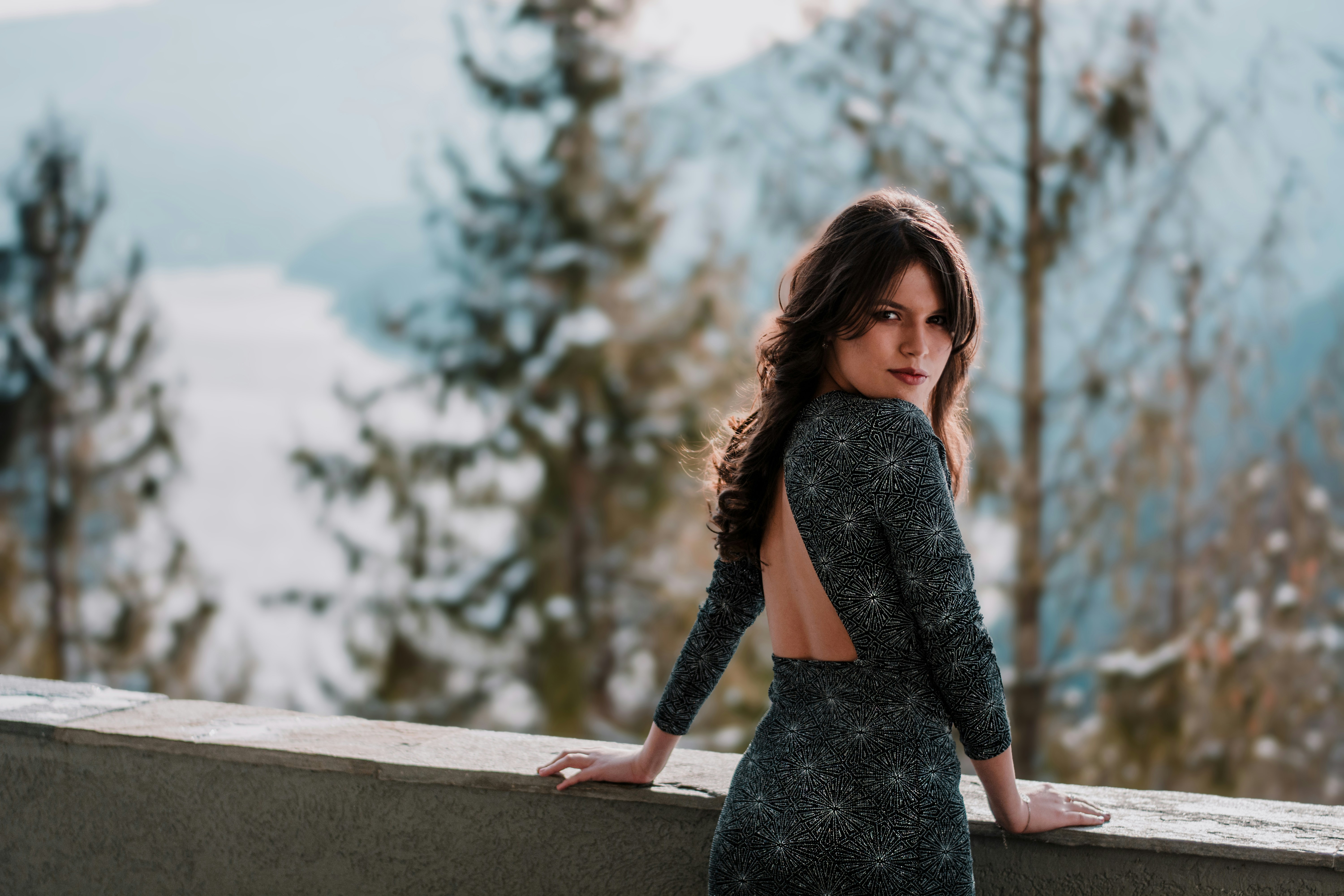 woman standing in front of gray concrete ledge