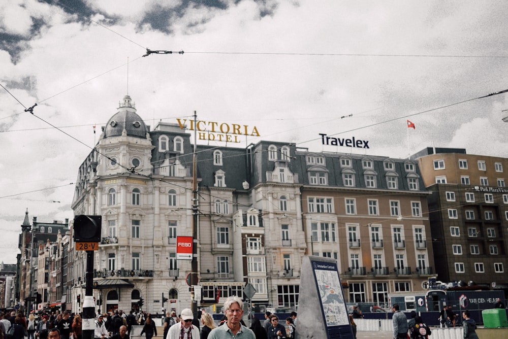 people walking near Victoria Hotel during daytime