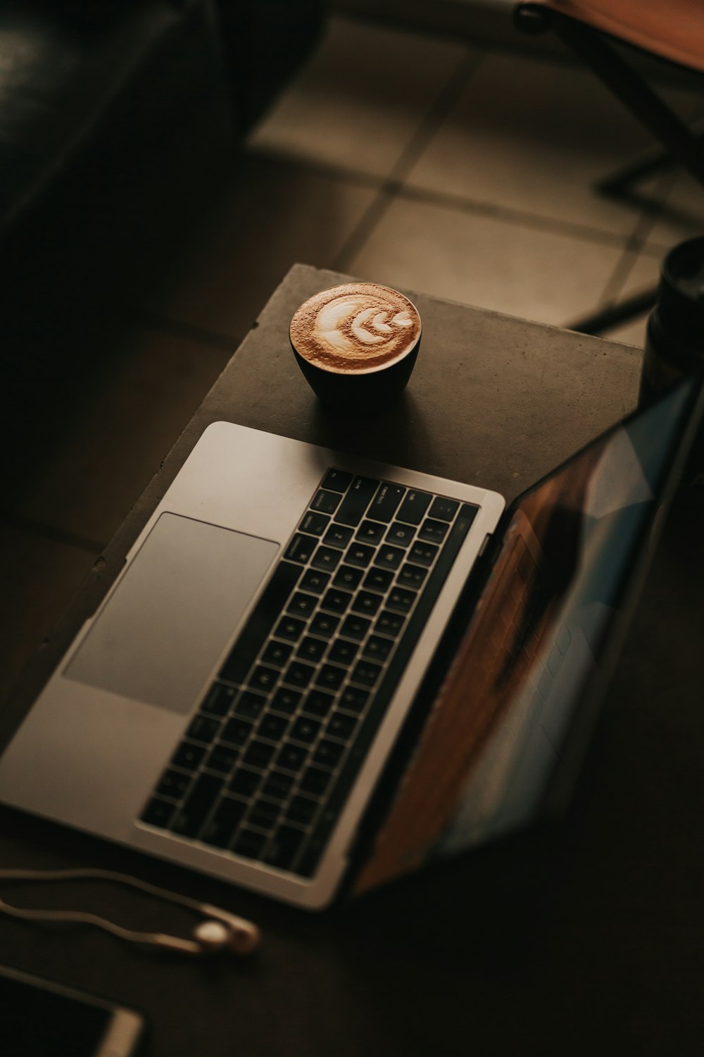 coffee latte beside MacBook Pro