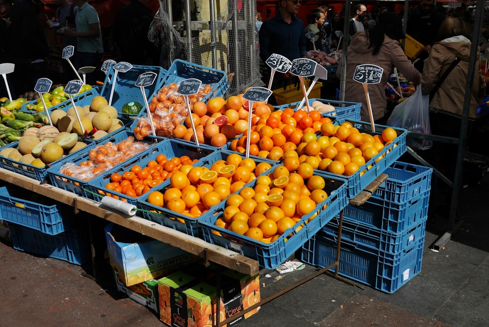 oranges on blue plastic crates