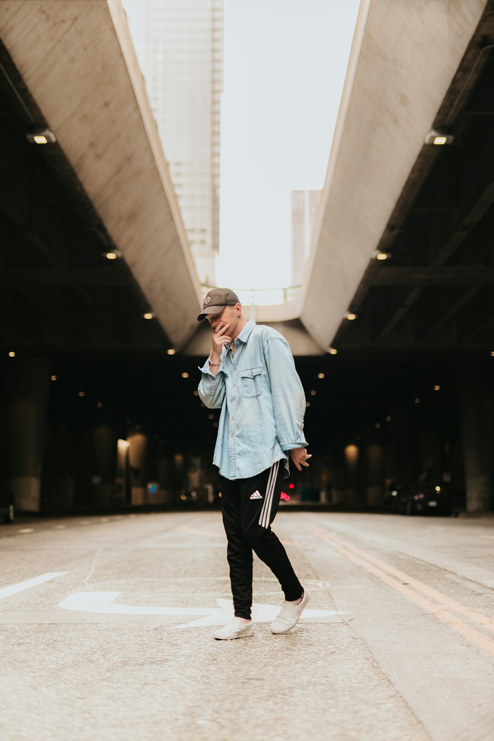 man standing alone and touching his face