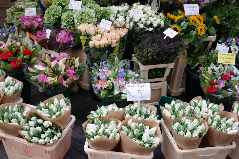 A vibrant display of fresh flowers in various colors at a market stall.